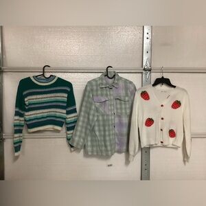 Two girls sweaters and one girls  flannel shirt size 10/12